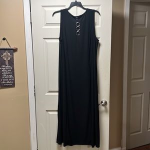 MSK 3x sleeveless black dress with silver rings on cleavage. Split on both sides